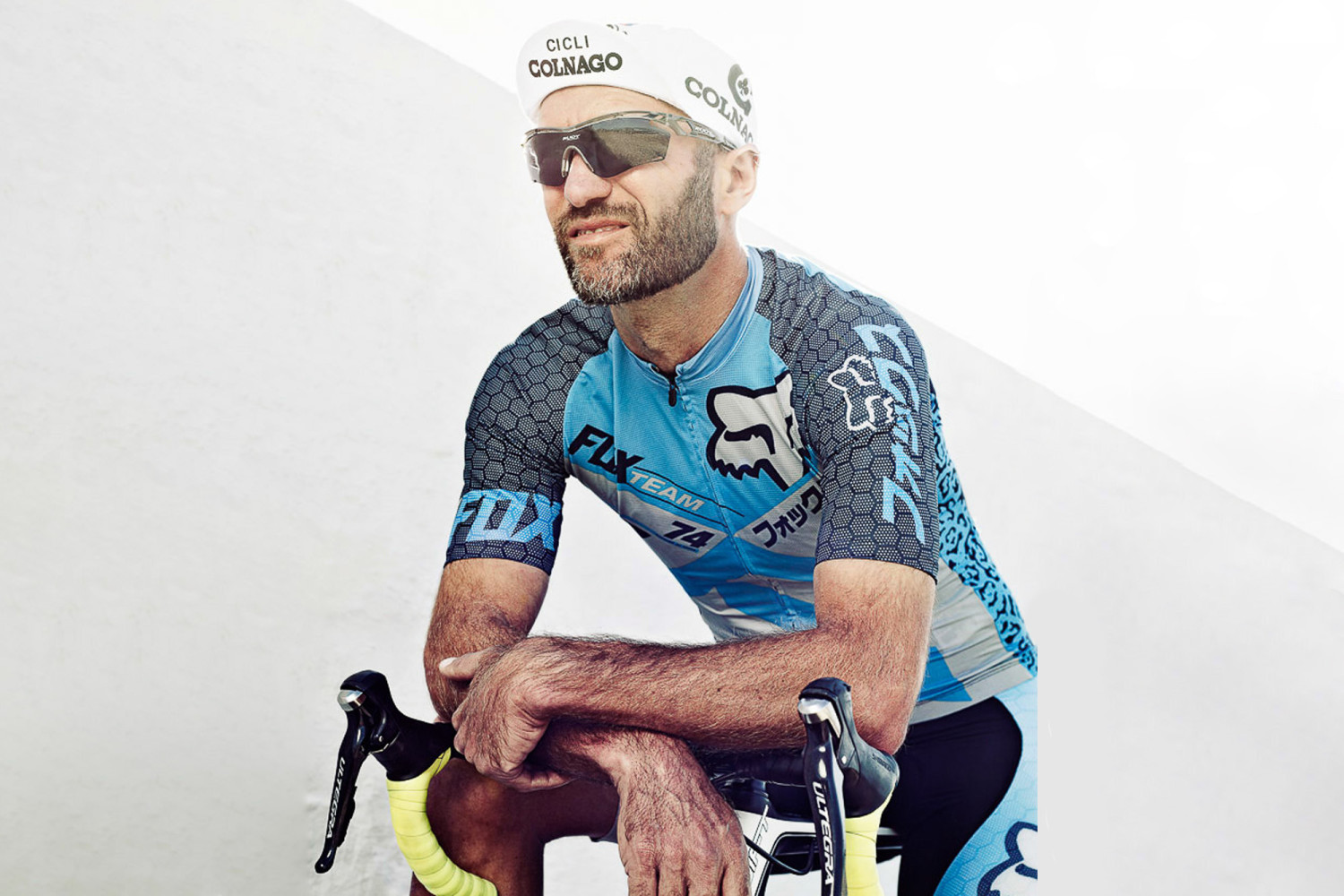 Cyclist in racing gear with bicycle outdoors