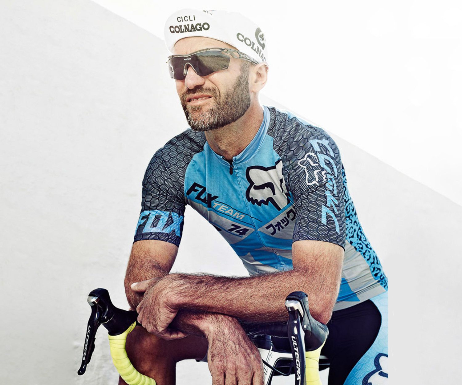 Cyclist in racing gear with bicycle outdoors