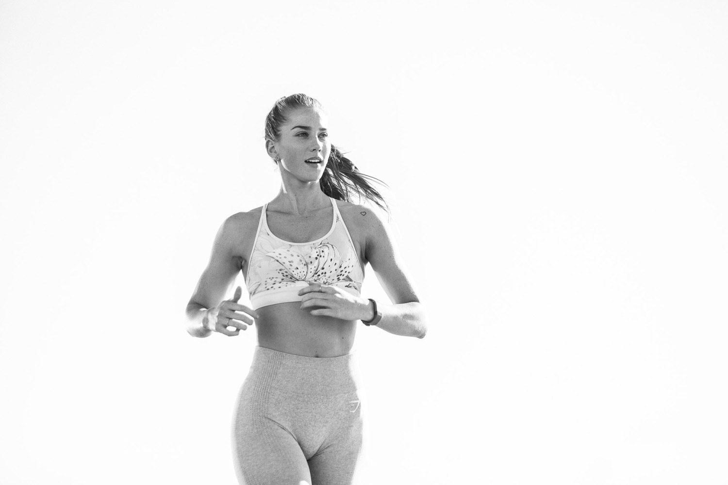 Woman jogging in athletic wear outdoors fitness