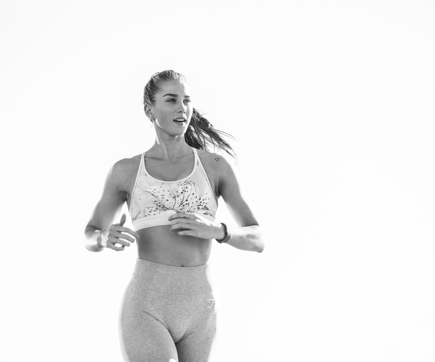 Woman jogging in athletic wear outdoors fitness