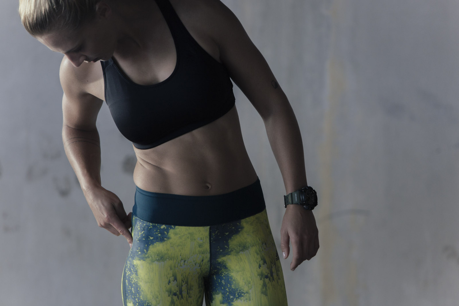 Woman in athletic wear checking her leggings