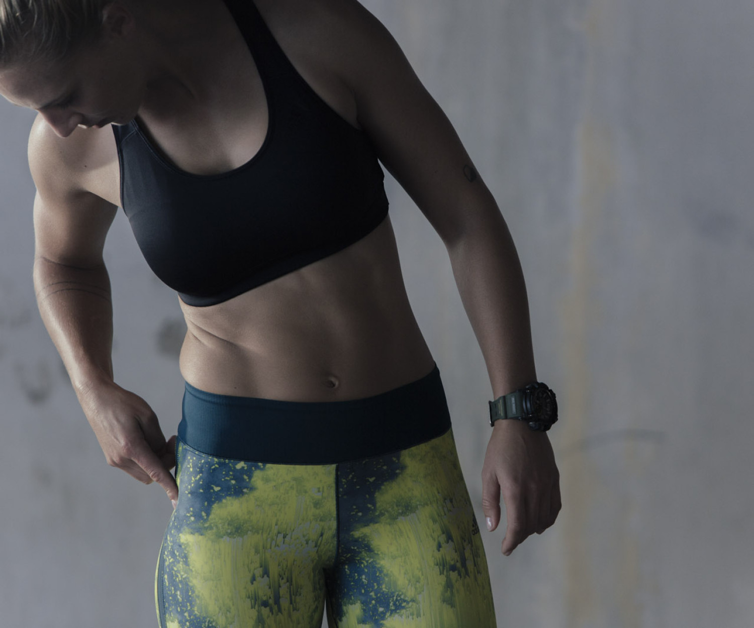 Woman in athletic wear checking her leggings