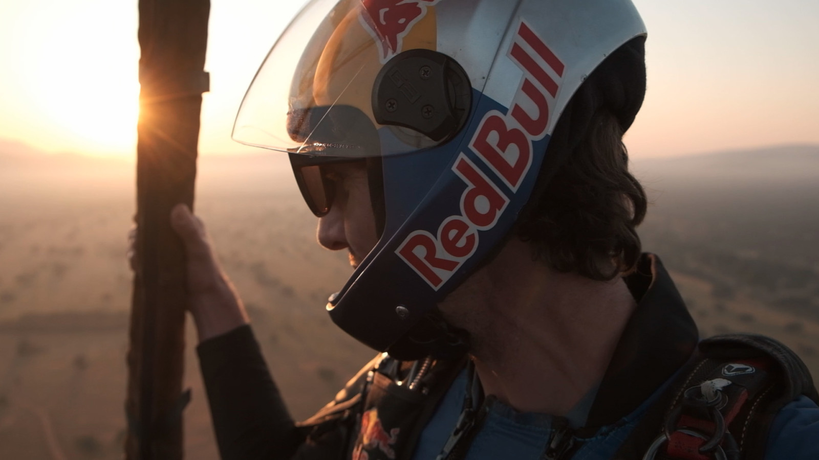 Paraglider soaring at sunset over scenic landscape by Cape Town photographer Casey Crafford