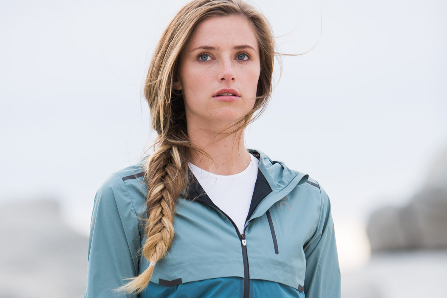 Young woman with braided hair outdoors gazing