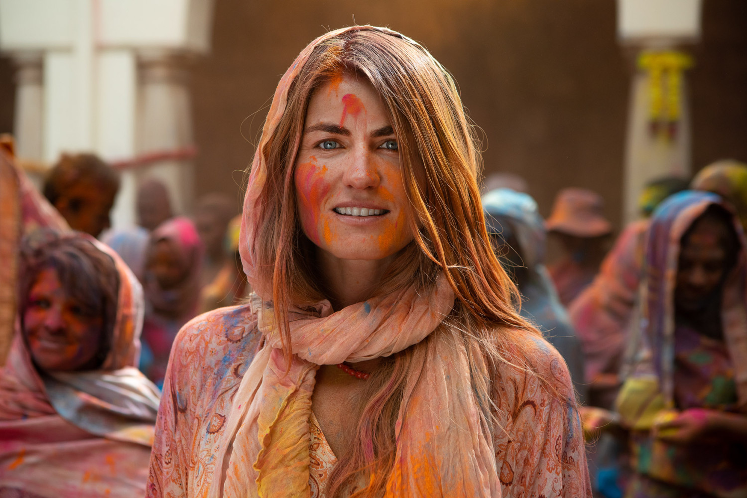Woman celebrating Holi festival with colorful powder