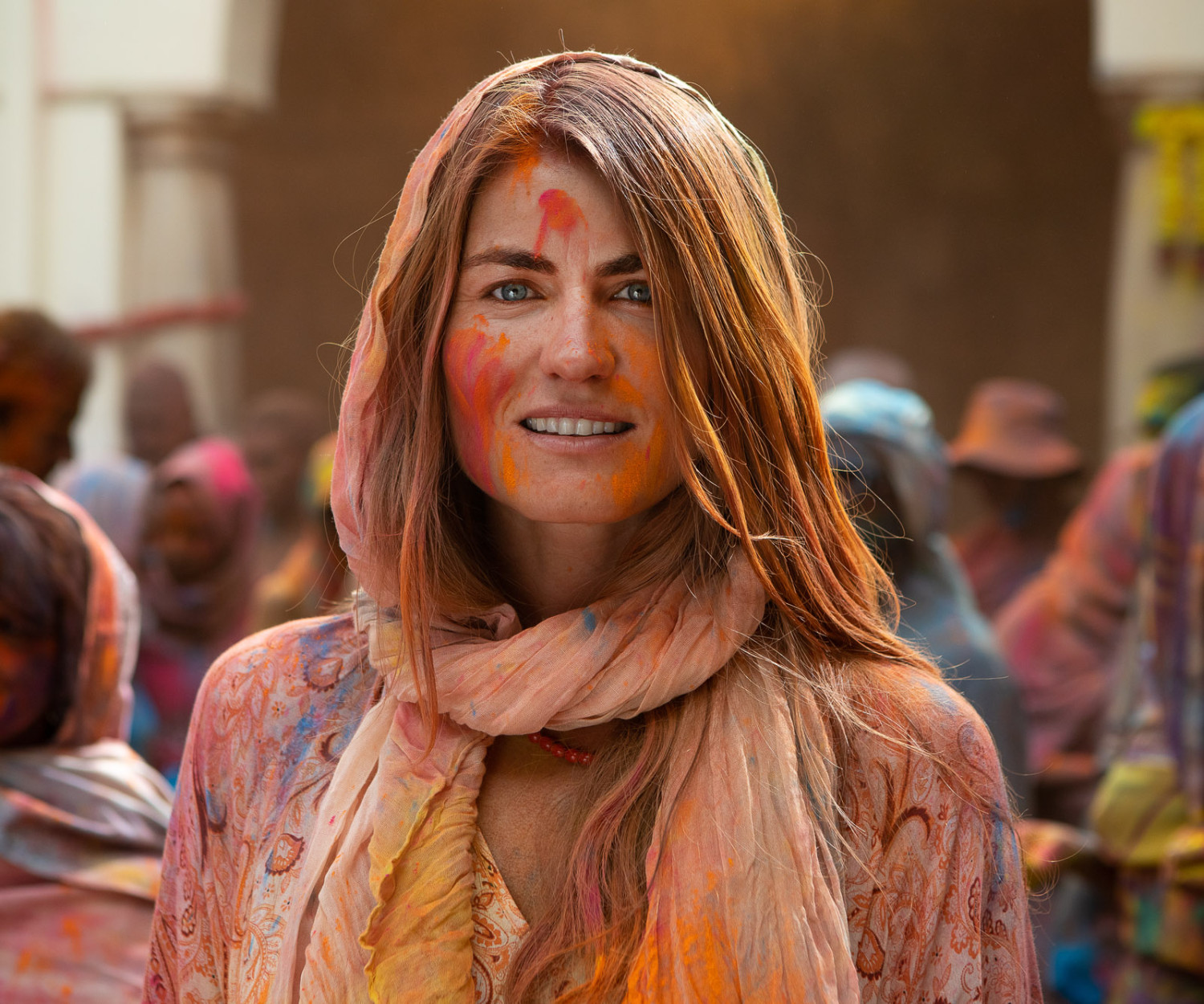 Woman celebrating Holi festival with colorful powder