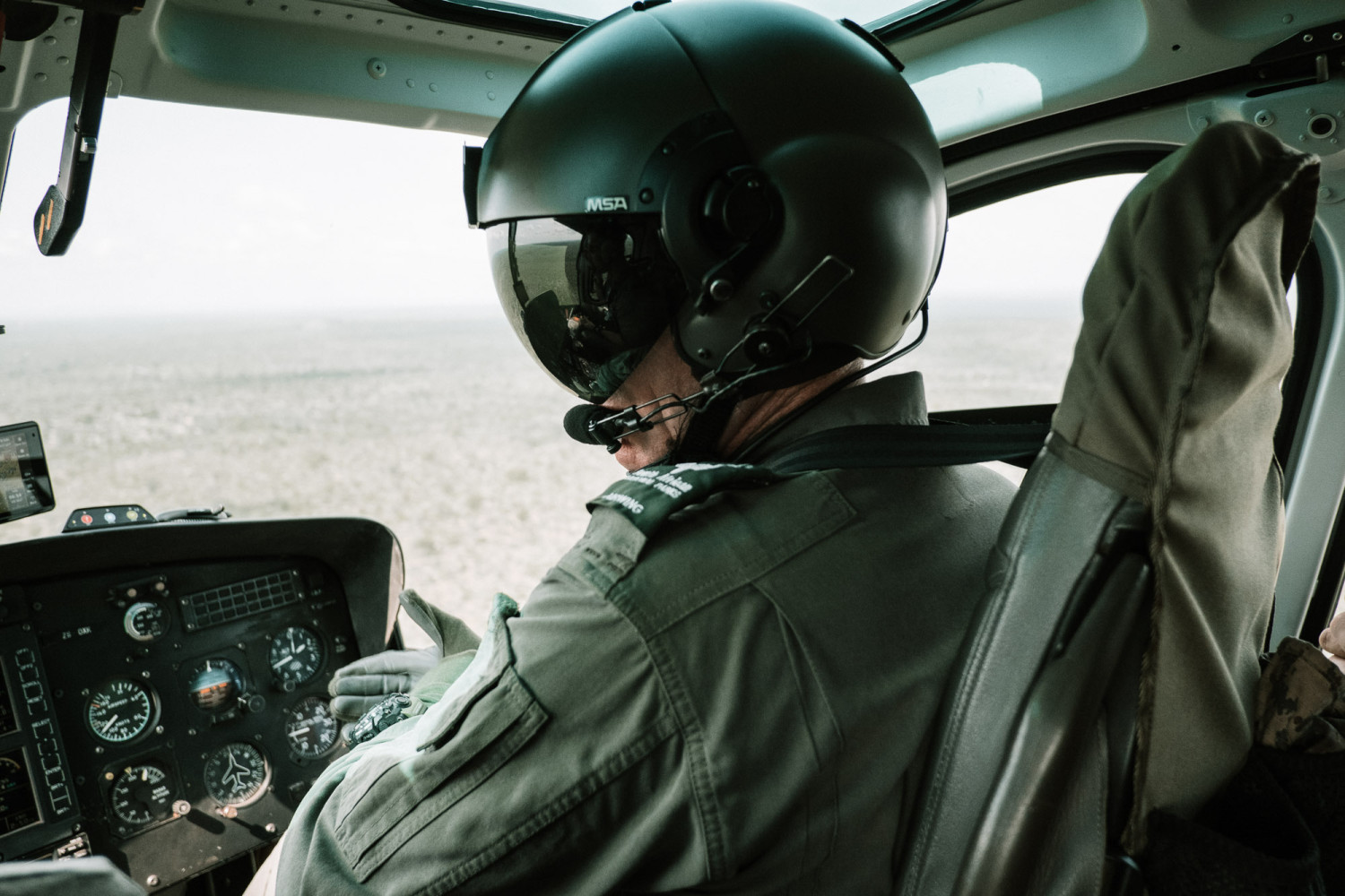 Helicopter pilot flying over vast landscape view