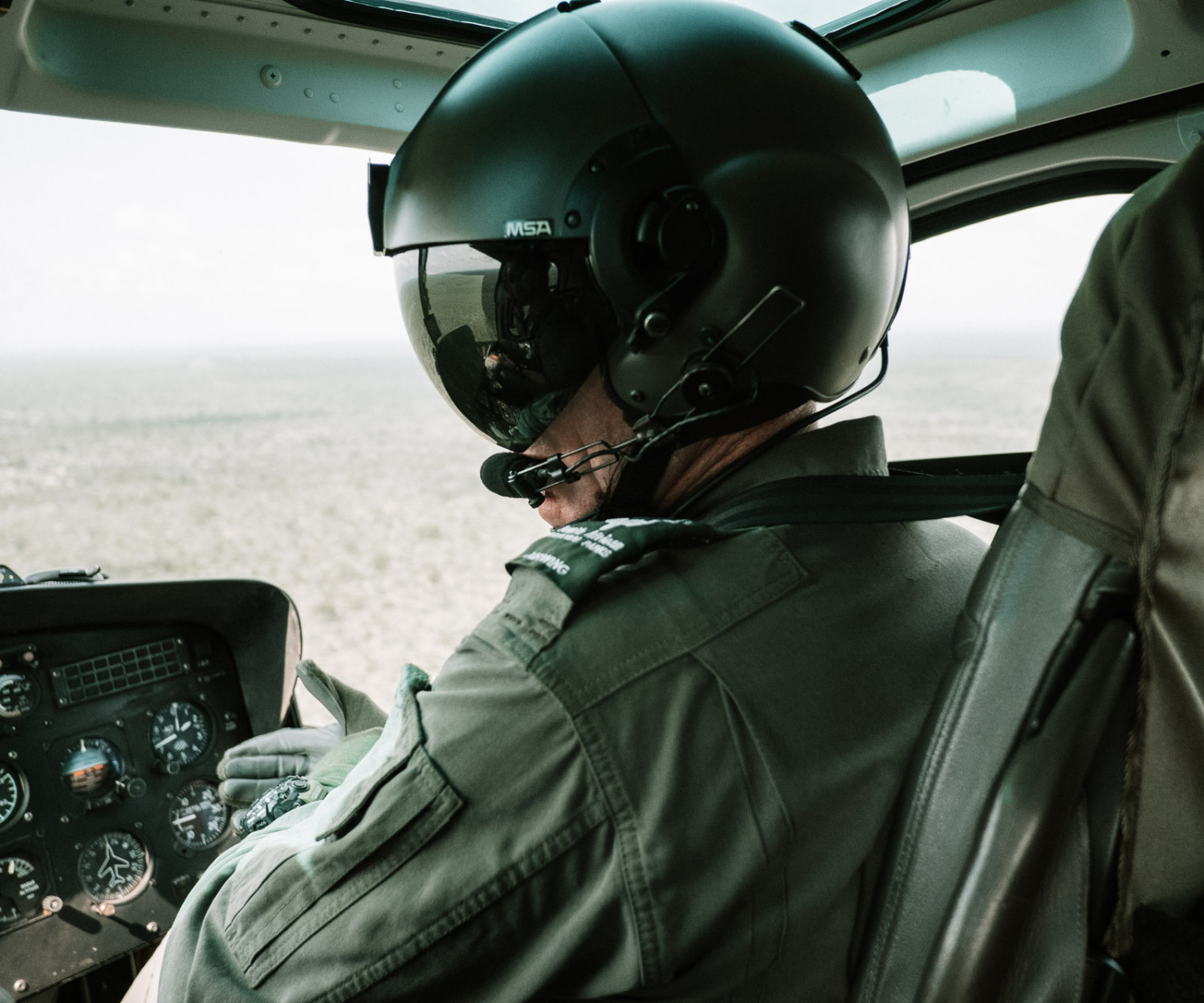 Helicopter pilot flying over vast landscape view