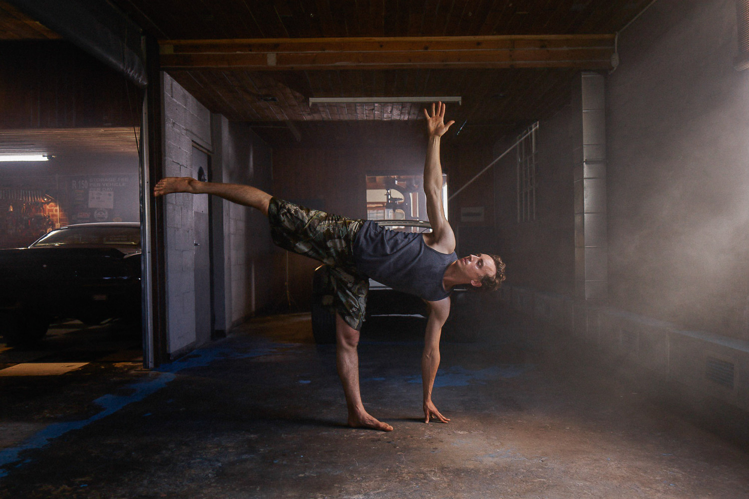 Man practicing yoga pose in industrial space