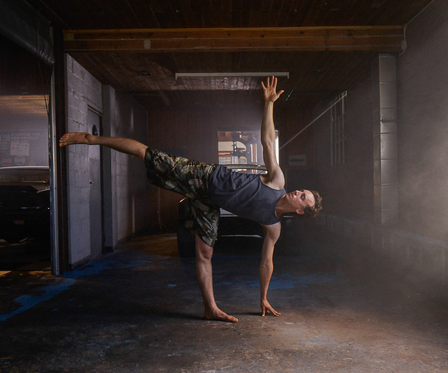 Man practicing yoga pose in industrial space