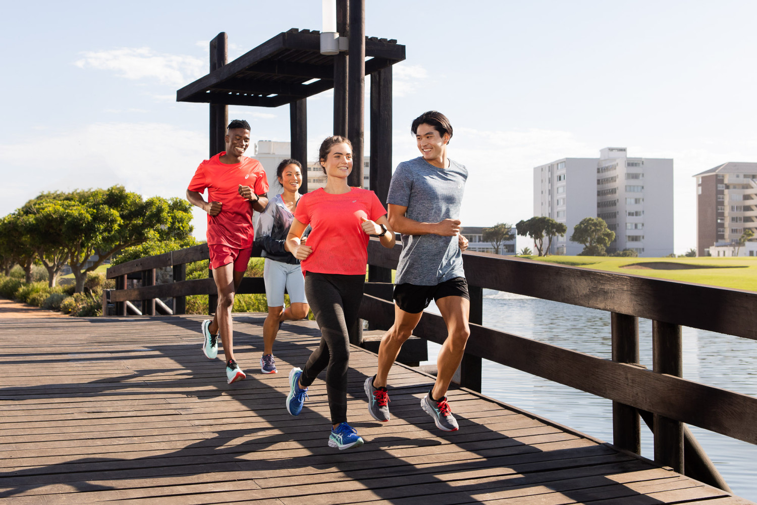 Group of people running on a bridge