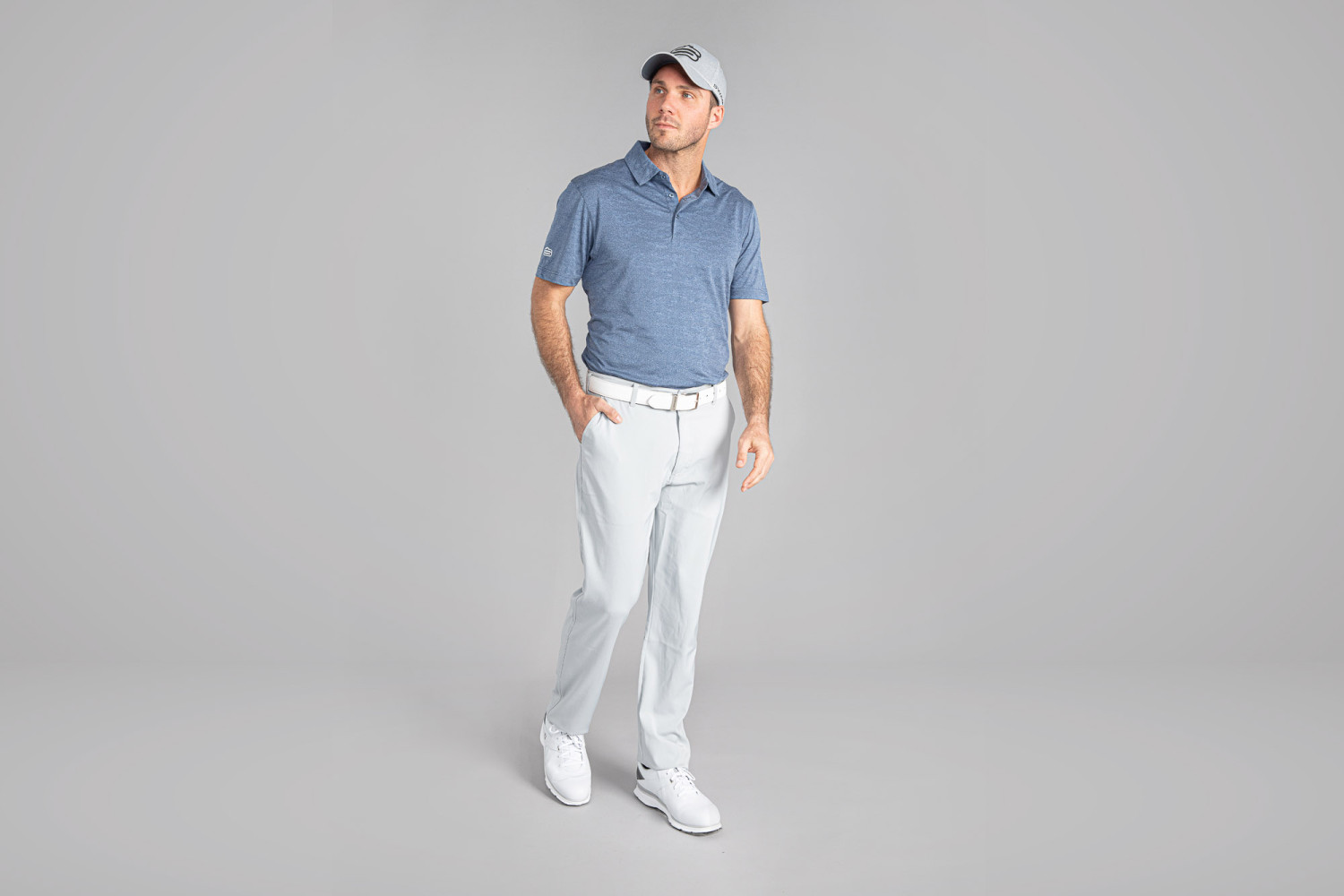 Man wearing casual blue shirt and white pants
