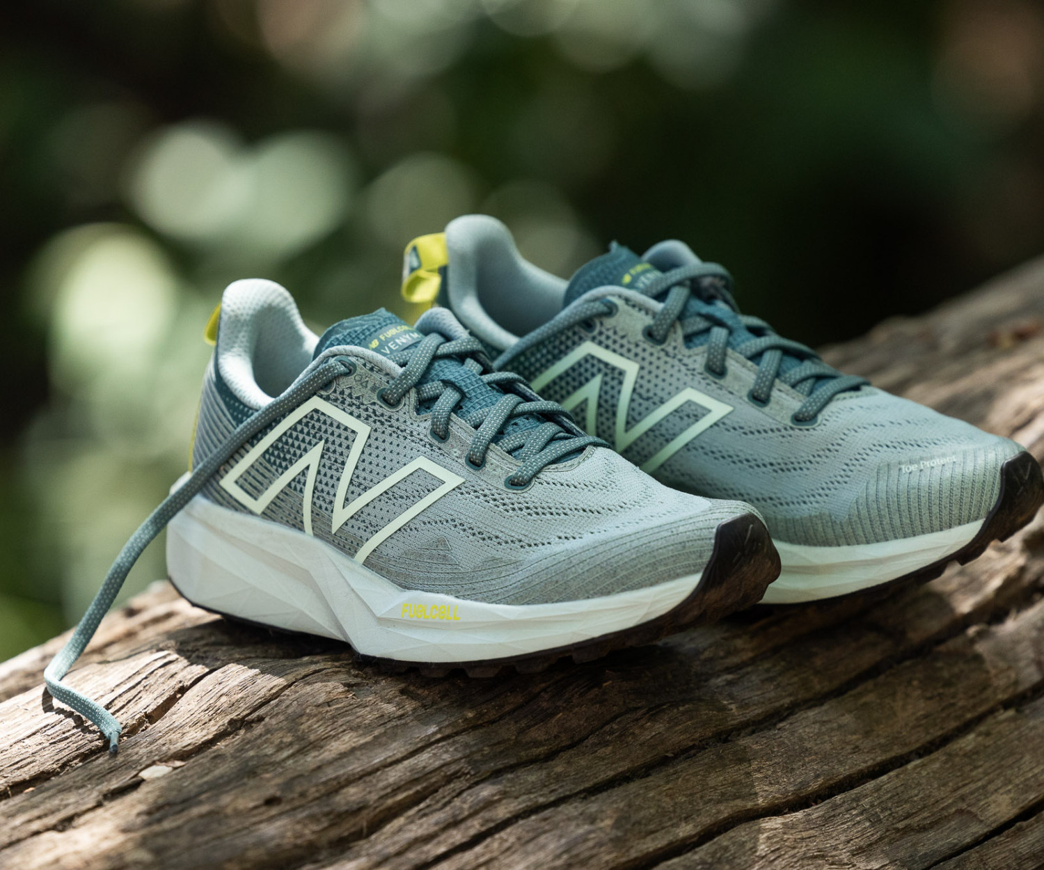 Gray running shoes on a wooden log