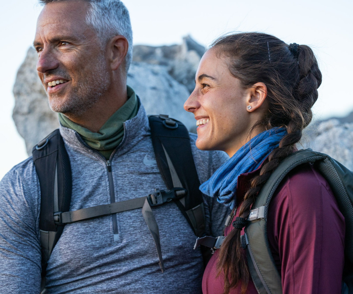 Smiling couple enjoys outdoor hiking adventure together