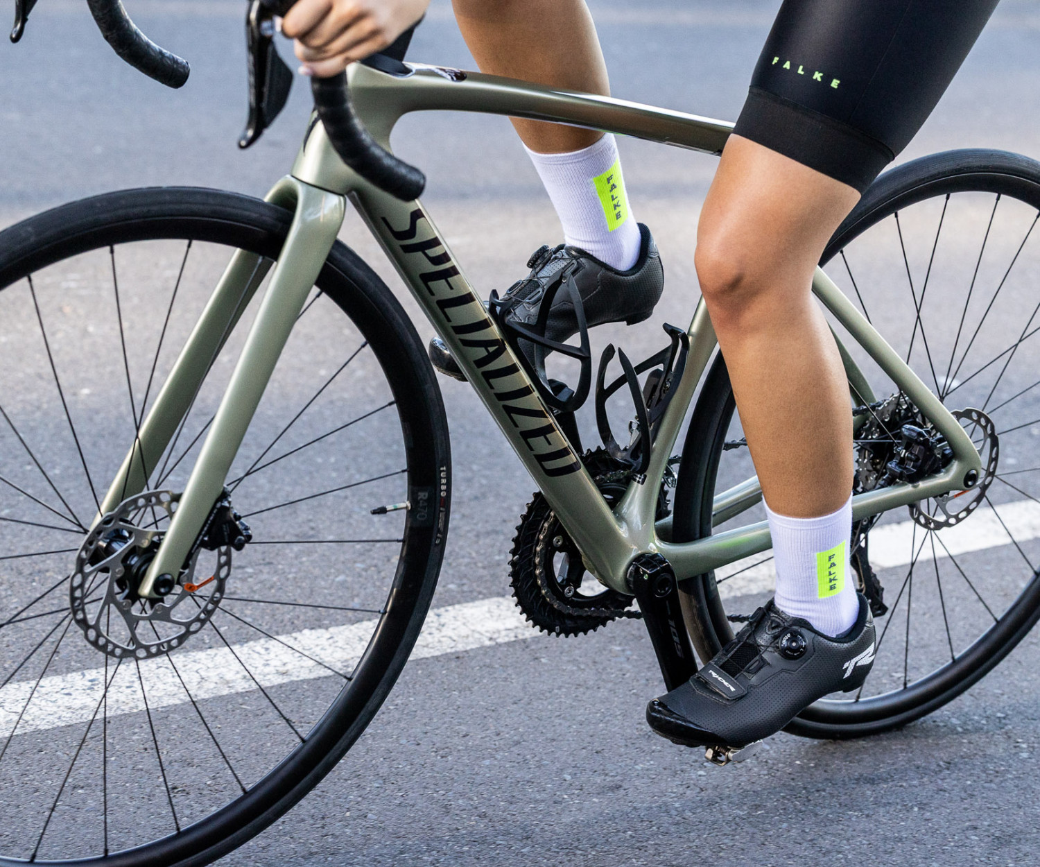 Person cycling on road with Specialized bicycle.