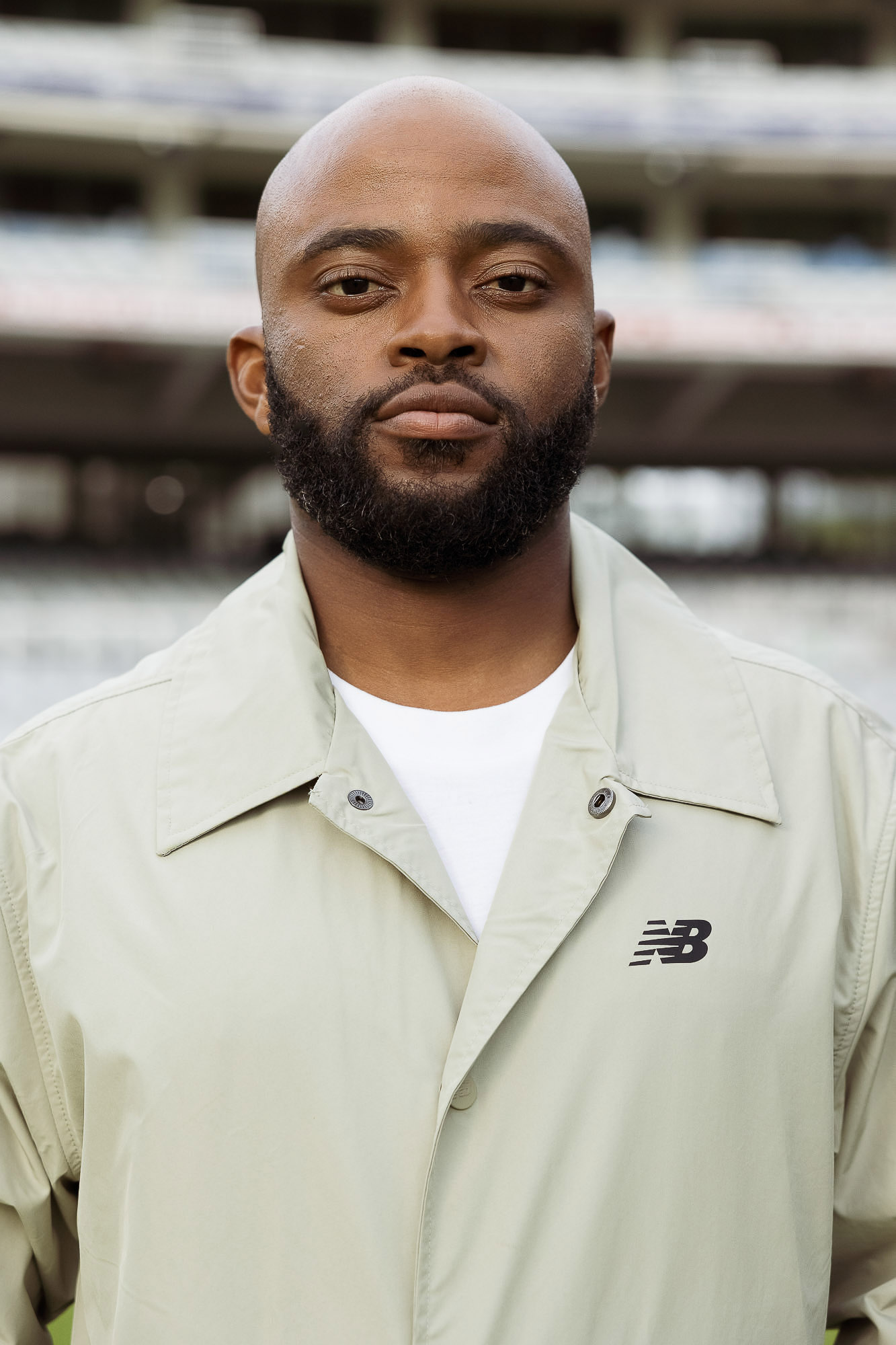 Fashion and brand photography of cricketer Temba Bavuma modeling a New Balance jacket.