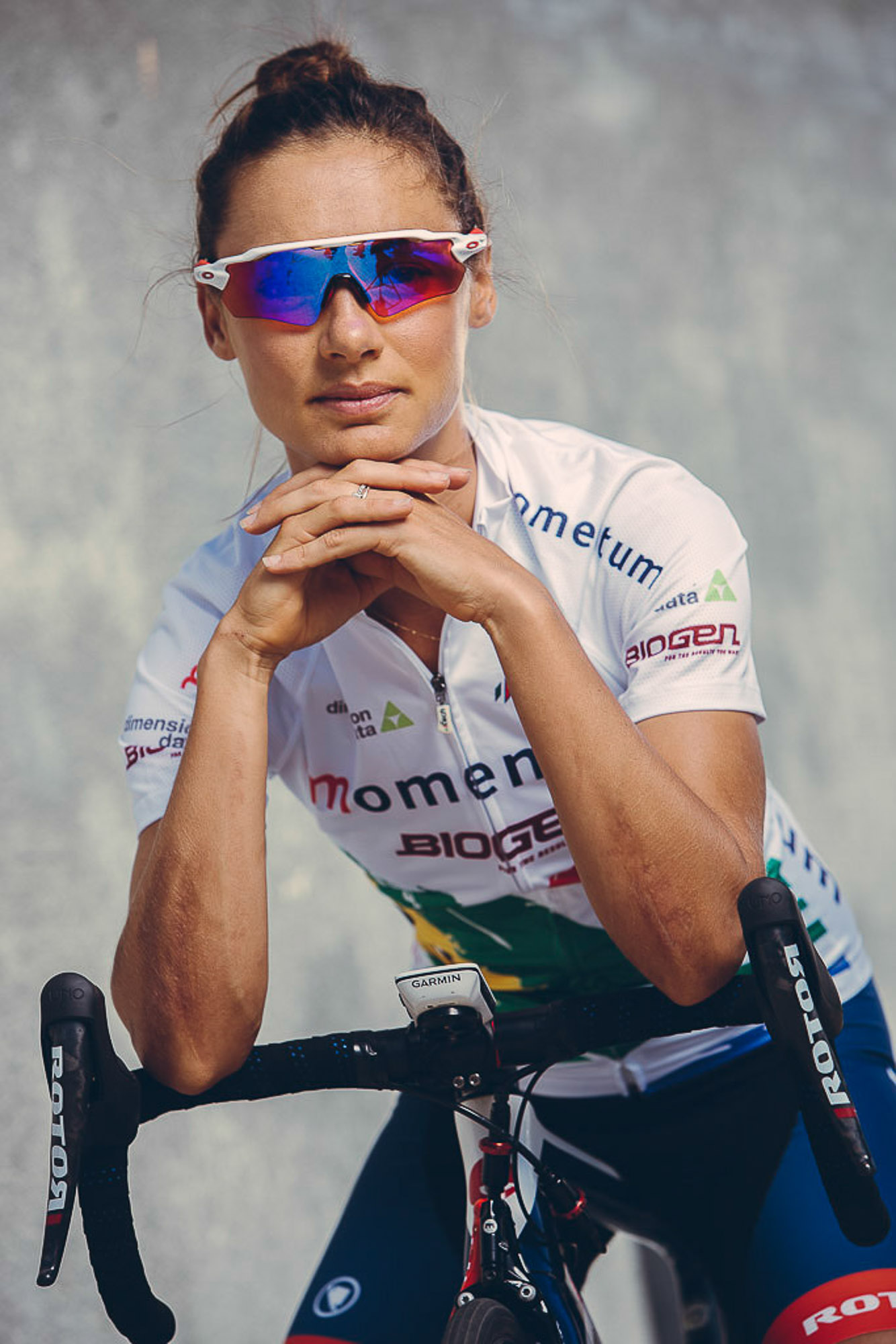 Cyclist Ashleigh Moolman Pasio posing with bicycle wearing sports attire by Cape Town photographer Casey Crafford