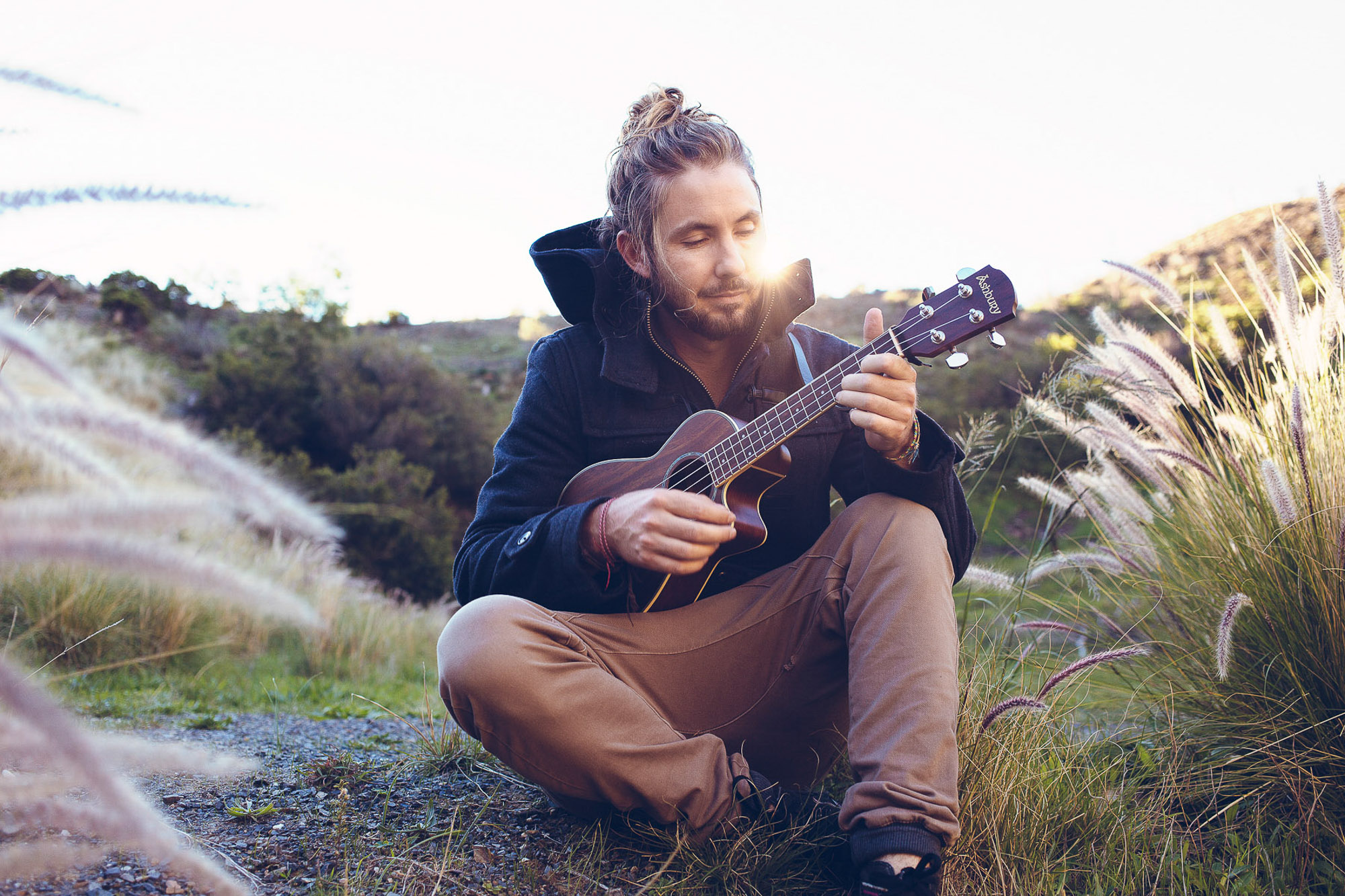 Jeremy Loops playing ukulele in nature scenery by Cape Town photographer Casey Crafford