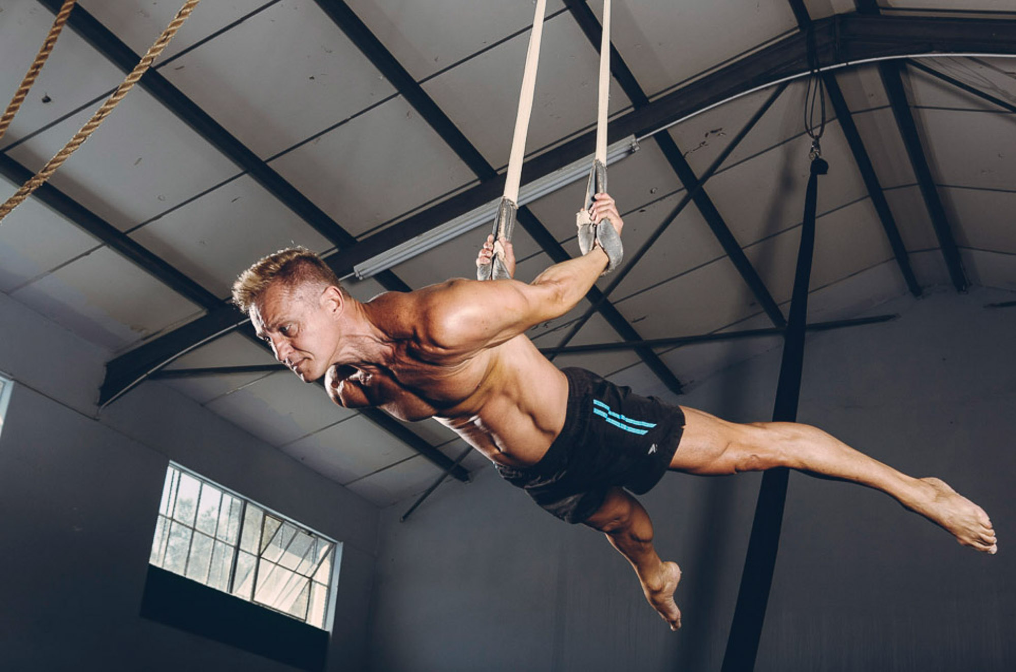 Athlete performing on gymnastic rings by Cape Town photographer Casey Crafford