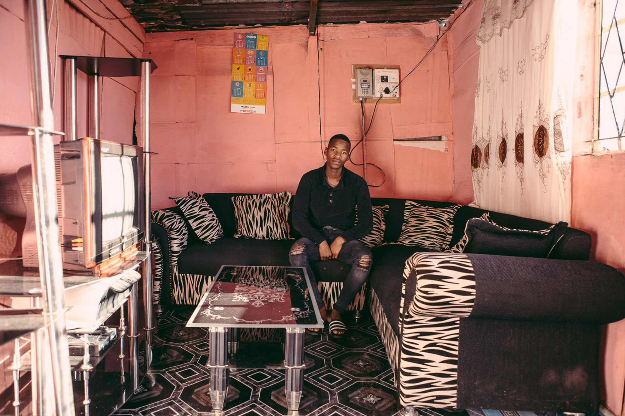 Cozy living room with pink walls and zebra print sofa by Cape Town photographer Casey Crafford