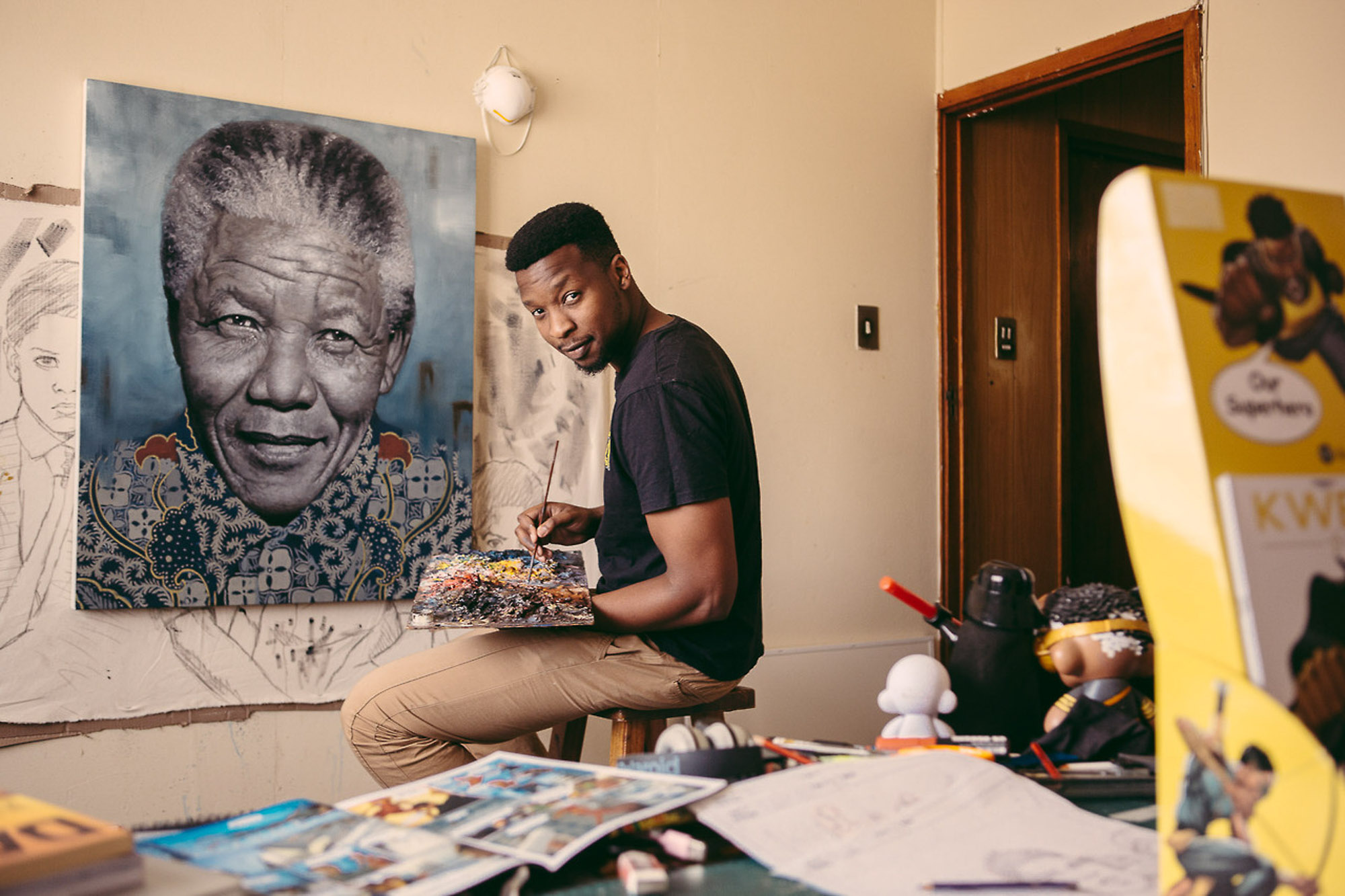 Loyiso Mkize painting a portrait in a creative studio by Cape Town photographer Casey Crafford